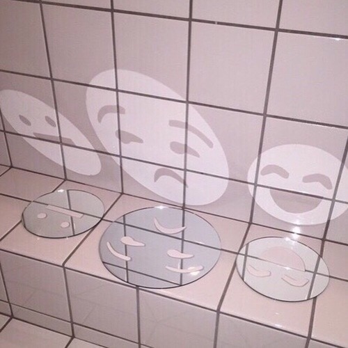 light reflecting in three emoji shaped mirrors