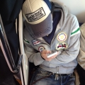 2013 nov 24 man on train knucklehead cap phone