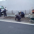 2014 jan 20 workers patching road wheelbarrows