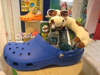 Uncle Cow wearin' shades on a pile of summer equipment in huge blue sandal
