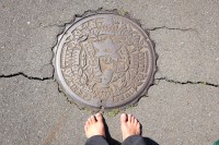 2021 apr 26 manhole cover with water character holding telescope